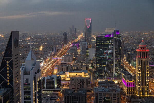 A view at night from above a city lit up with lights.