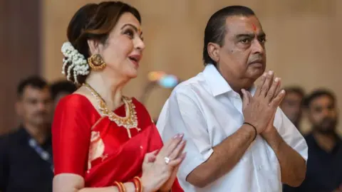 EPA Reliance Industries chairman Mukesh Ambani (R) and his wife Neeta Ambani gesture during a mass wedding ceremony for underprivileged couples at Reliance Corporate Park, in Navi Mumbai, India, 02 July 2024. 