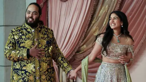 Reuters Anant Ambani, son of businessman Mukesh Ambani, arrives with his fiance  Radhika Merchant on the red carpet during the sangeet ceremony at Jio World Centre, Mumbai, India, July 5, 2024.