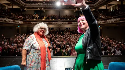 Bradford Literature Festival Miriam Margolyes posing for a selfie with audience behind her