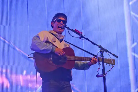 PA Media Gerry Cinnamon strumming guitar and performing live